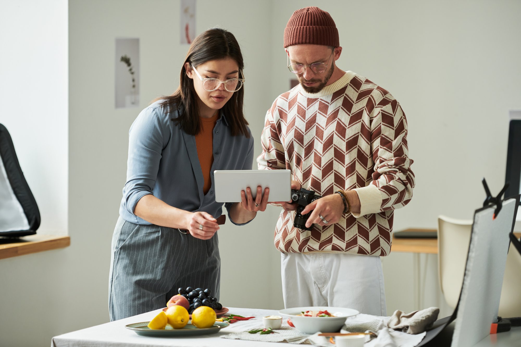 A professional chef guiding a home cook in a bright kitchen